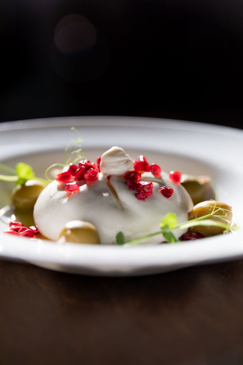 Burrata sa narom i maslinama na tamnoj pozadini